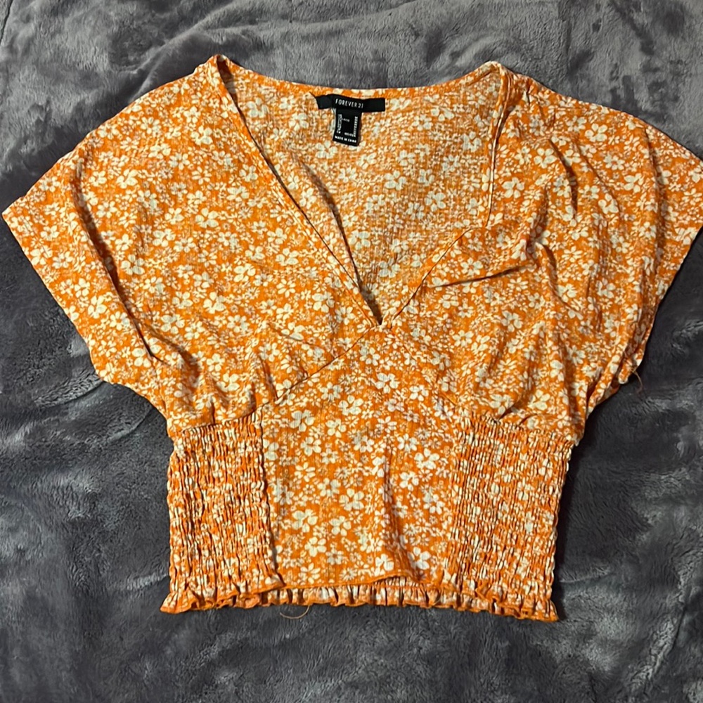 orange and white floral blouse